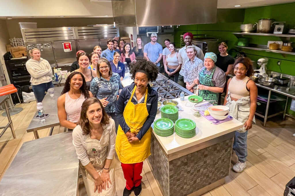 Students pose in an industrial kitchen.