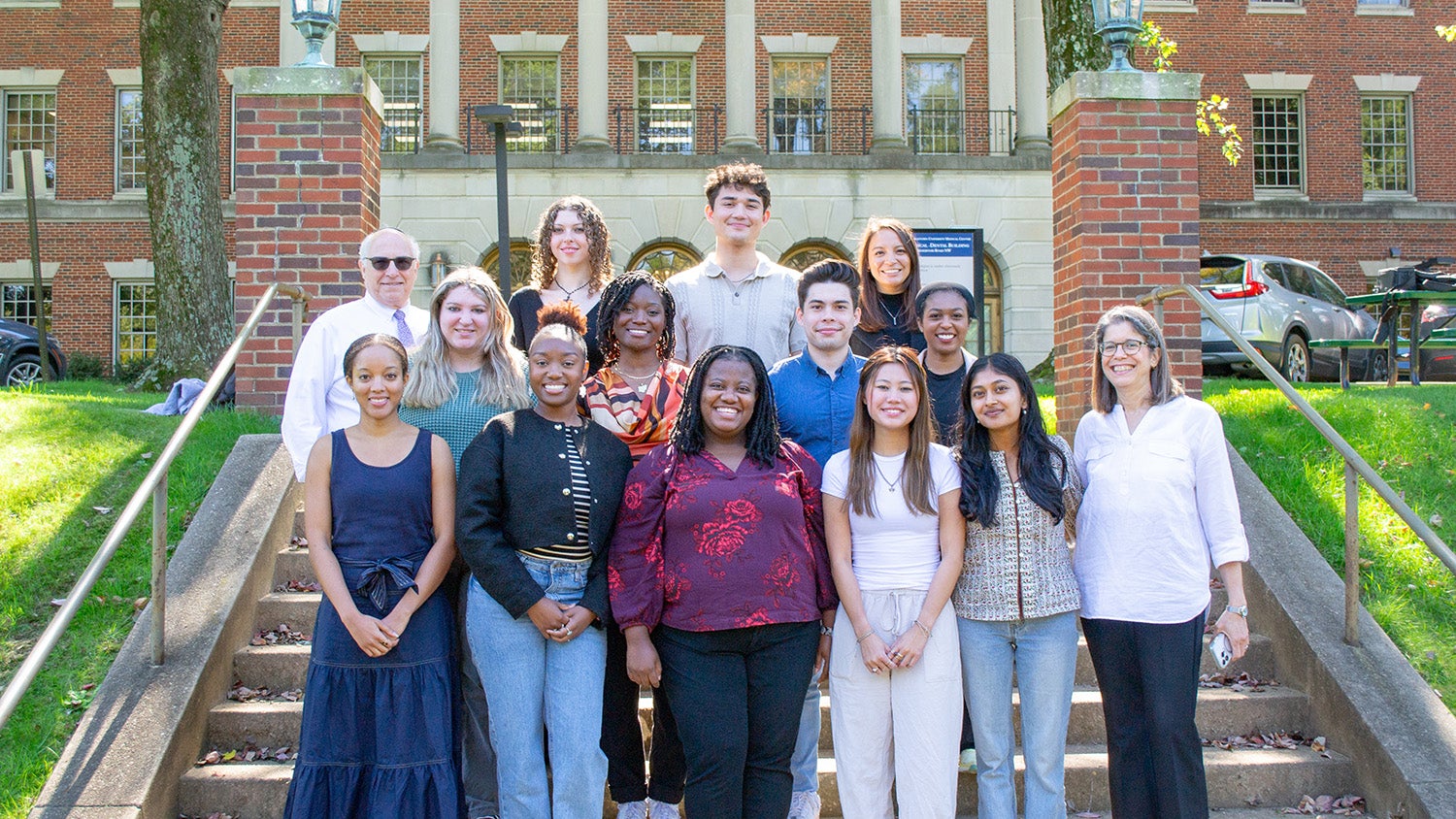 Students pose with Dr. Amri and Dr. Haramati on the Medical and Dental Building Steps.